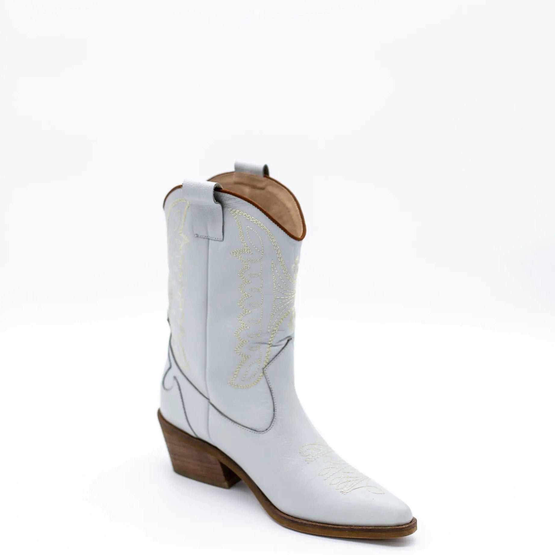 Introducing the Luna Cowboy Boot — a handcrafted statement piece designed for unstoppable style, comfort, and individuality. The Luna boot is where rustic tradition meets modern elegance, offering a fresh twist on the timeless cowboy boot silhouette. Whether you're walking down the aisle or dancing under the stars, Luna brings a unique edge to your look with artisanal detailing and heritage craftsmanship while offering that unique 'Something Blue' element.