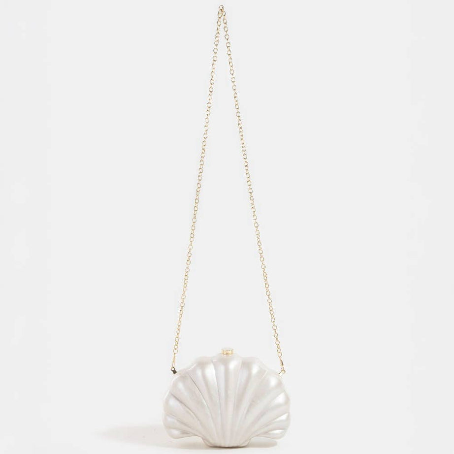 Shell-shaped white pearlescent bridal clutch bag on a light grey background