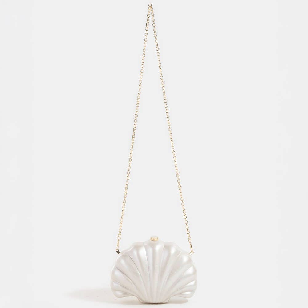 Shell-shaped white pearlescent bridal clutch bag on a light grey background
