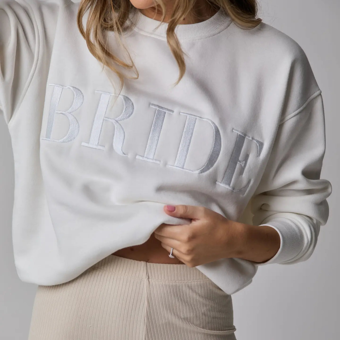 Lady wearing white Six Stories Bride Sweater 