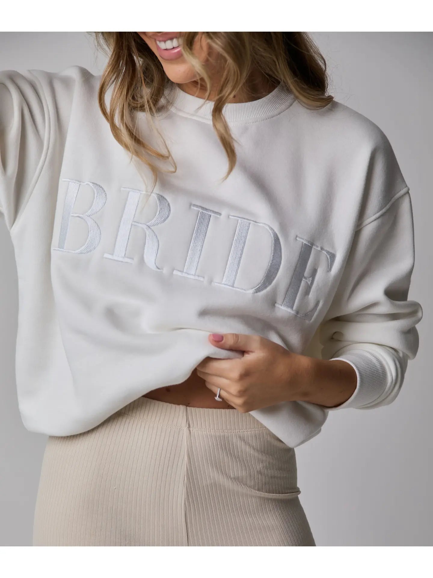 Lady wearing white Six Stories Bride Sweater 