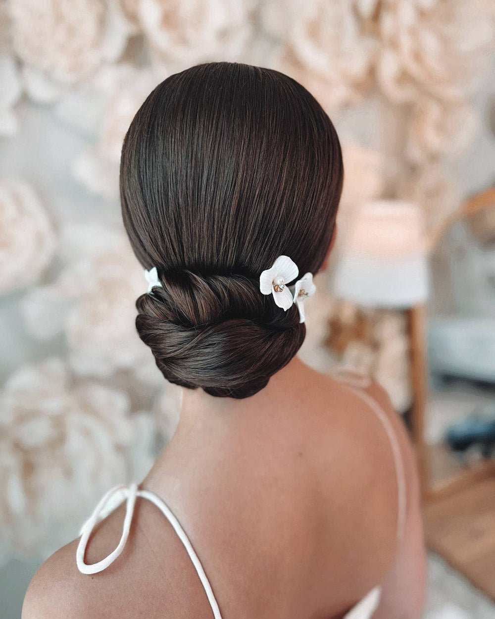Elevate your bridal hairstyle with timeless sophistication and romantic charm with the Kylee Ivory Floral Hair Pins. Sold as a set of three, each pin is a delicate work of art, meticulously handcrafted to add a soft, feminine touch to your special day. Whether you're walking down the aisle, attending an engagement party, or preparing for a bridal photoshoot, these floral hair pins are the perfect accessory to complete your look.