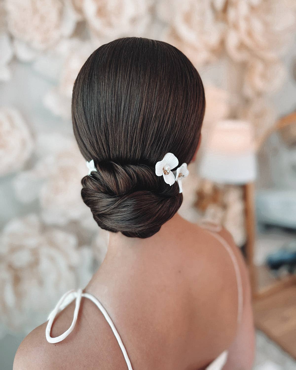 Elevate your bridal hairstyle with timeless sophistication and romantic charm with the Kylee Ivory Floral Hair Pins. Sold as a set of three, each pin is a delicate work of art, meticulously handcrafted to add a soft, feminine touch to your special day. Whether you're walking down the aisle, attending an engagement party, or preparing for a bridal photoshoot, these floral hair pins are the perfect accessory to complete your look.