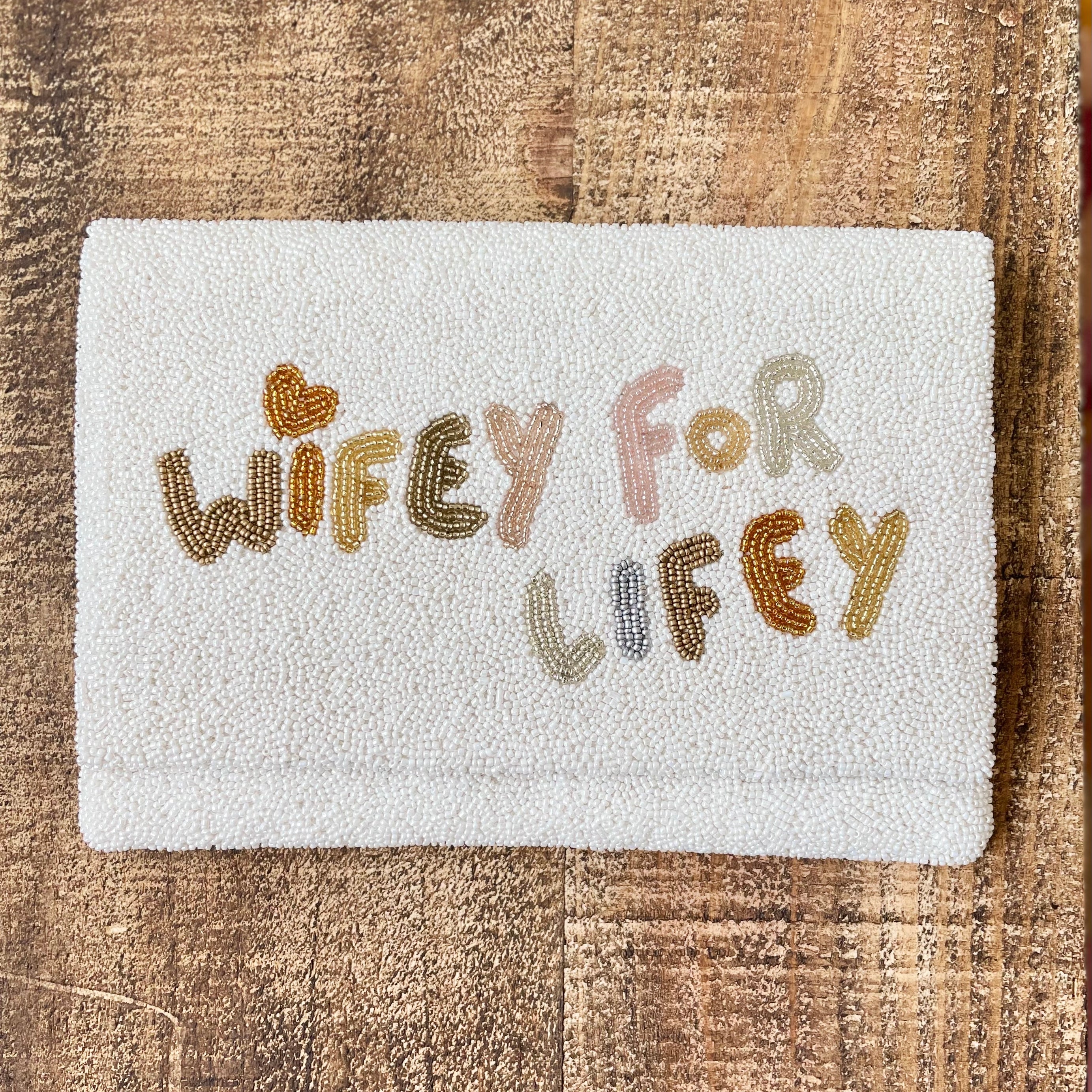 wifey for lifey beaded bridal handbag on wooden shelf