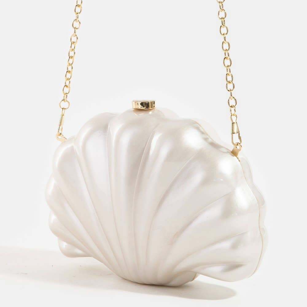 Shell-shaped white pearlescent bridal clutch bag on a light grey background