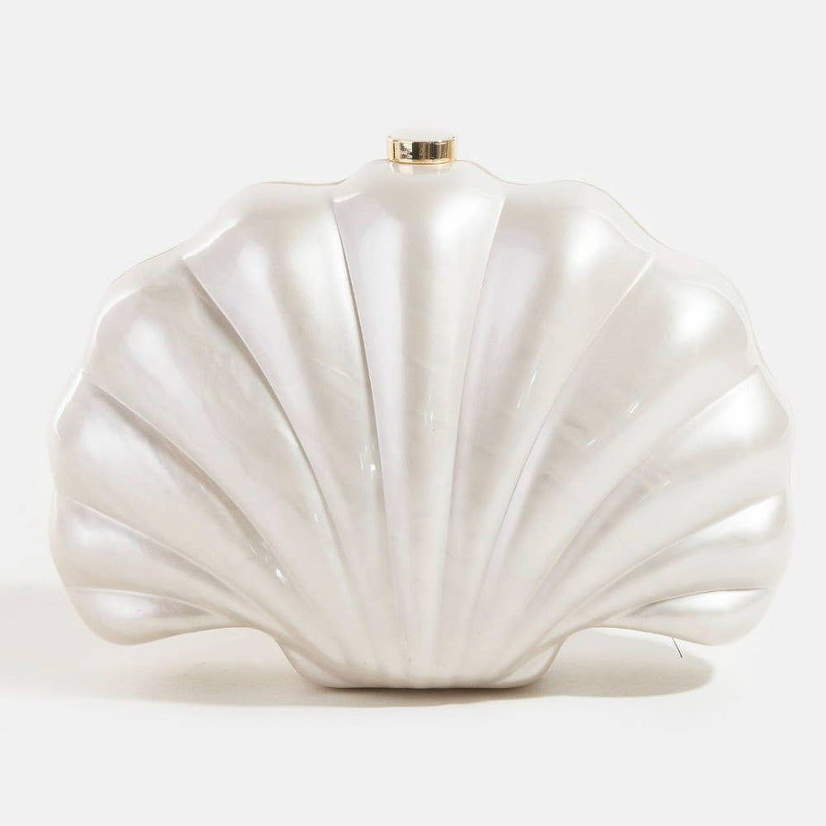 Shell-shaped white pearlescent bridal clutch bag on a light grey background