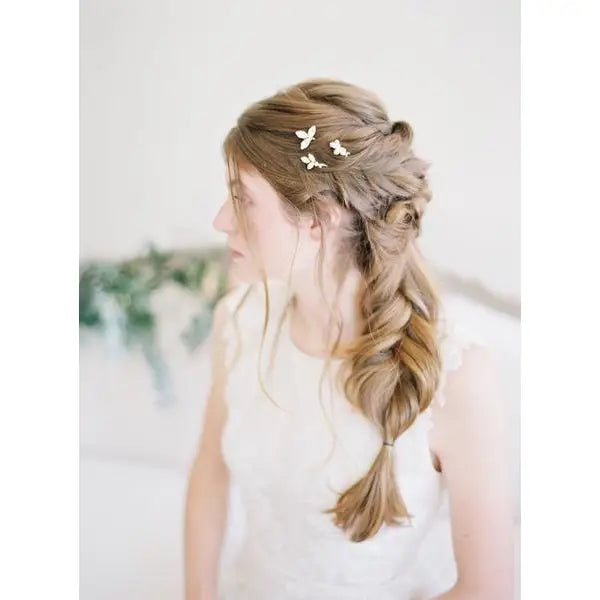 Add a touch of refined sparkle to your look with our Cleo Crystal Hairpin Set, A trio of delicate and dazzling hairpins— the perfect finishing touch for brides, bridesmaids, or anyone attending a special occasion. Handcrafted with delicate gold-toned wiring and shimmering crystal accents, these pins bring effortless elegance and luminous detail to any hairstyle.