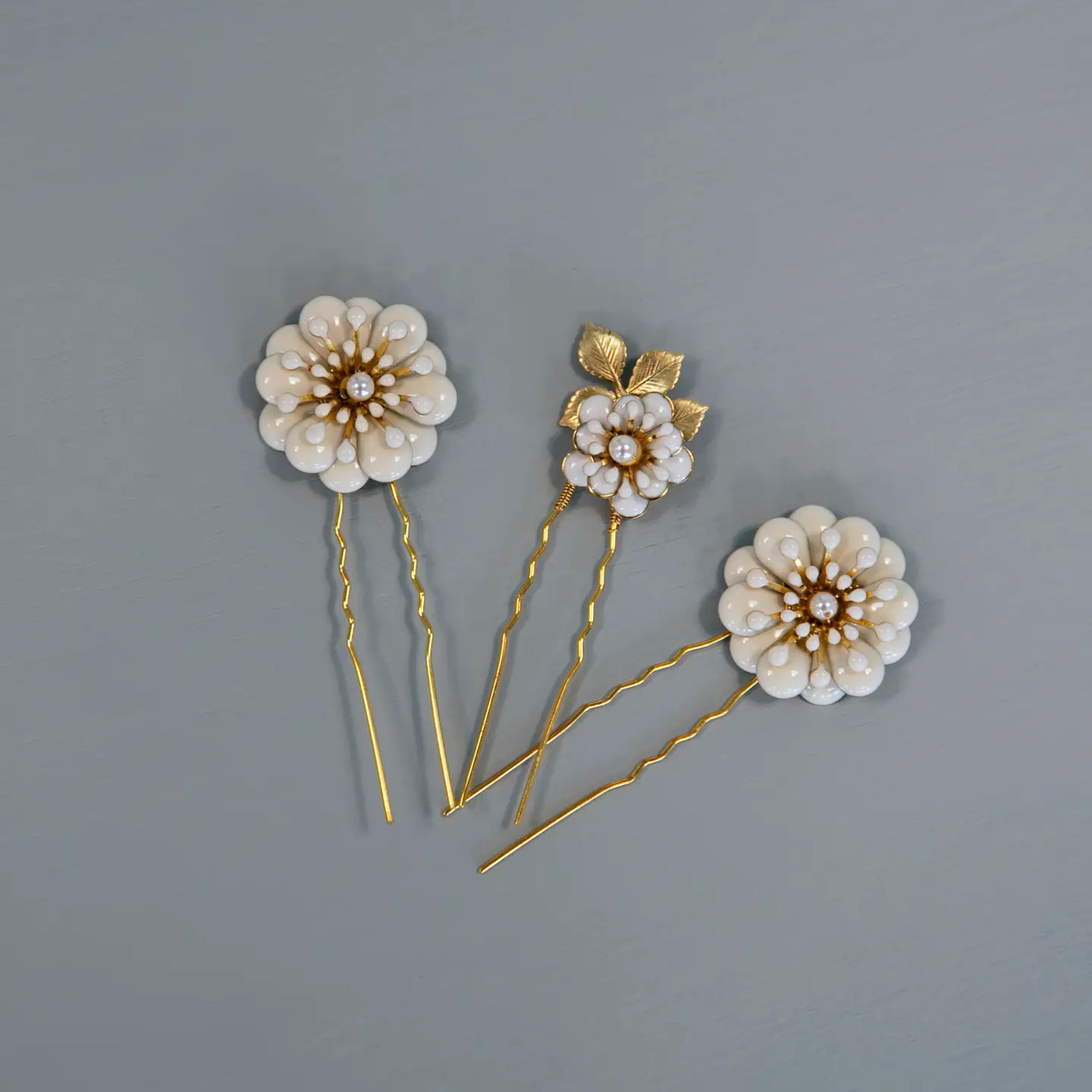 Add a touch of floral elegance to your look with the Daisy trio Hairpin Set — the perfect finishing touch for brides, bridesmaids, or anyone attending a special occasion. Handcrafted with delicate gold-toned wiring and shimmering crystal accents, these pins bring effortless elegance and luminous detail to any hairstyle.