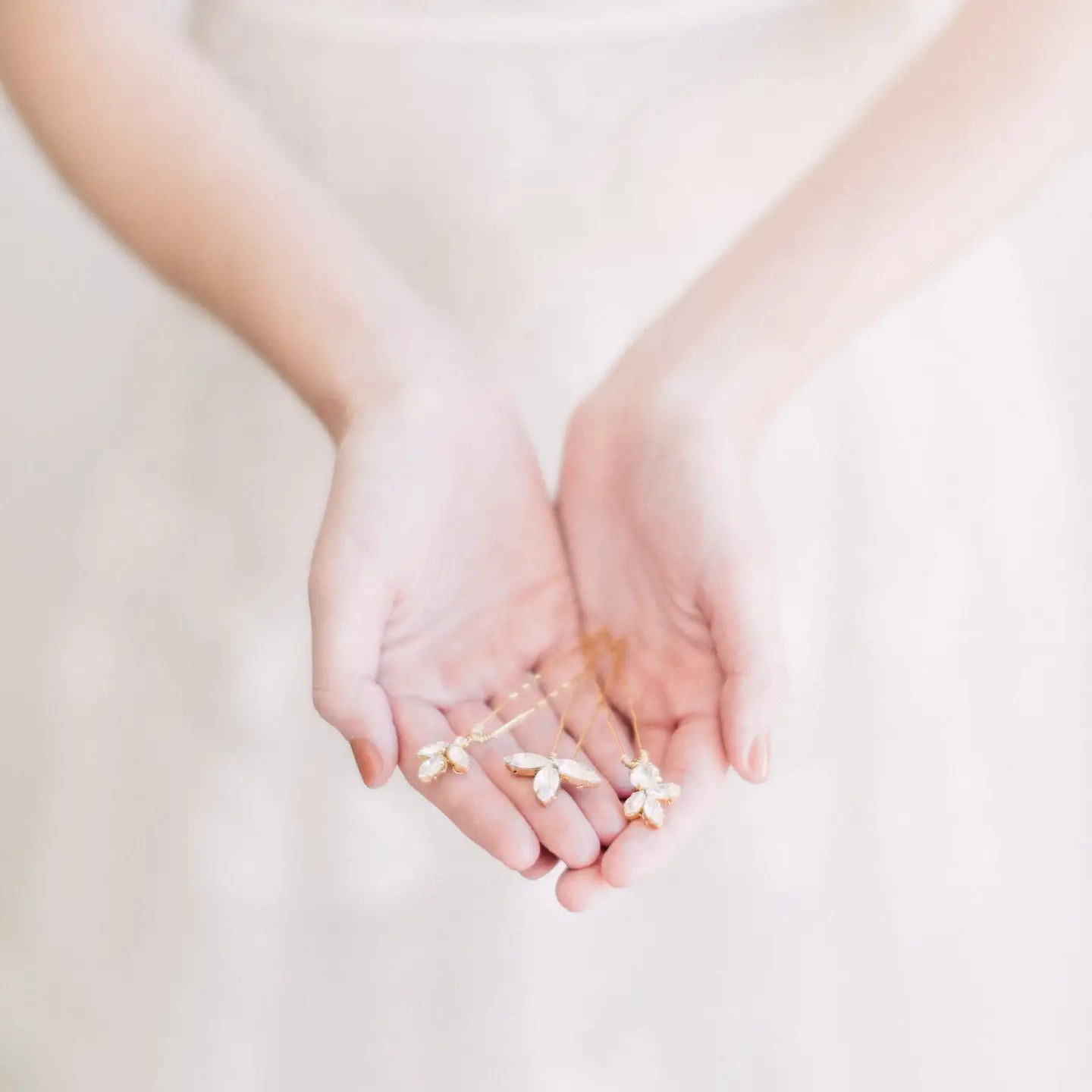 Add a touch of refined sparkle to your look with our Cleo Crystal Hairpin Set, A trio of delicate and dazzling hairpins— the perfect finishing touch for brides, bridesmaids, or anyone attending a special occasion. Handcrafted with delicate gold-toned wiring and shimmering crystal accents, these pins bring effortless elegance and luminous detail to any hairstyle.