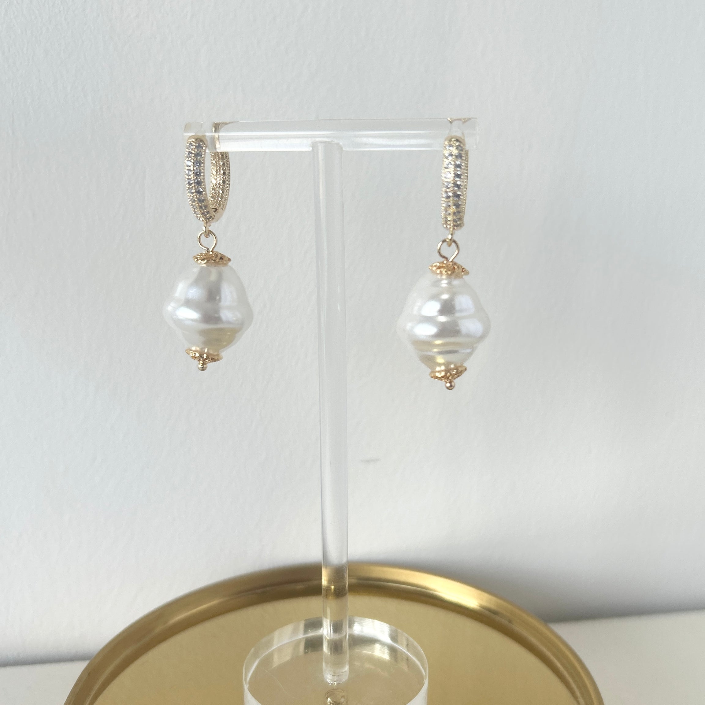 Pearl earrings on a gold stand