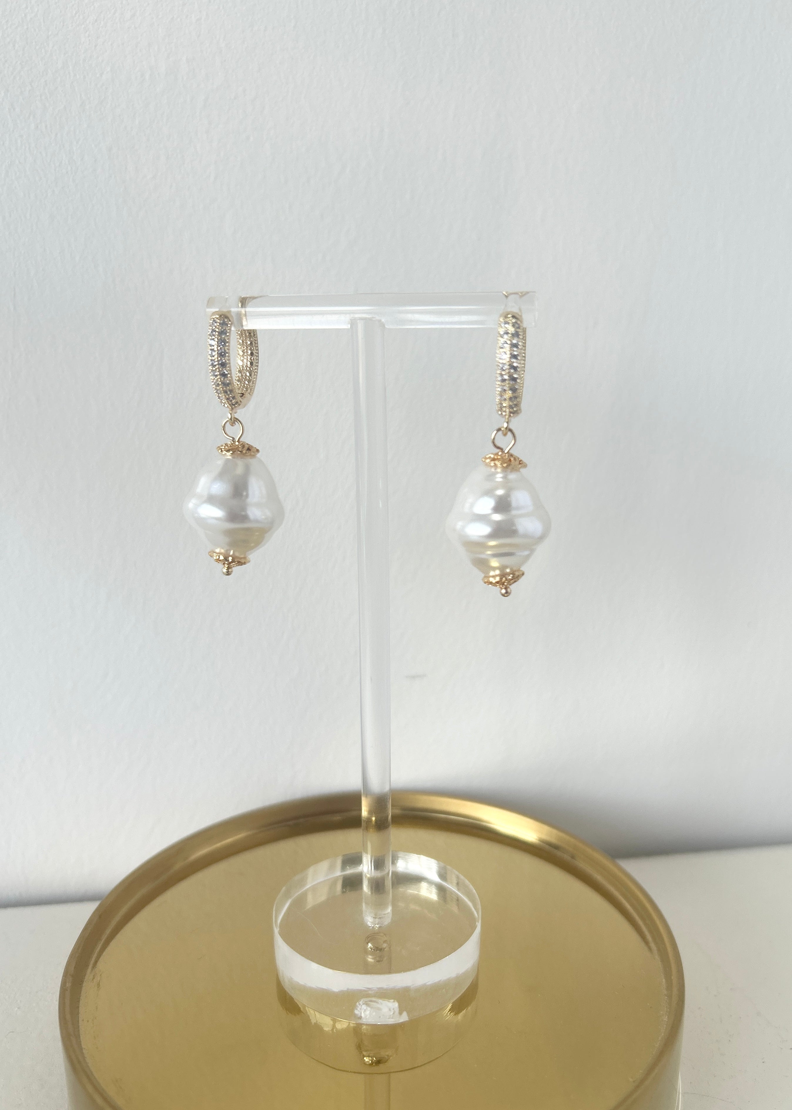 Pearl earrings on a gold stand