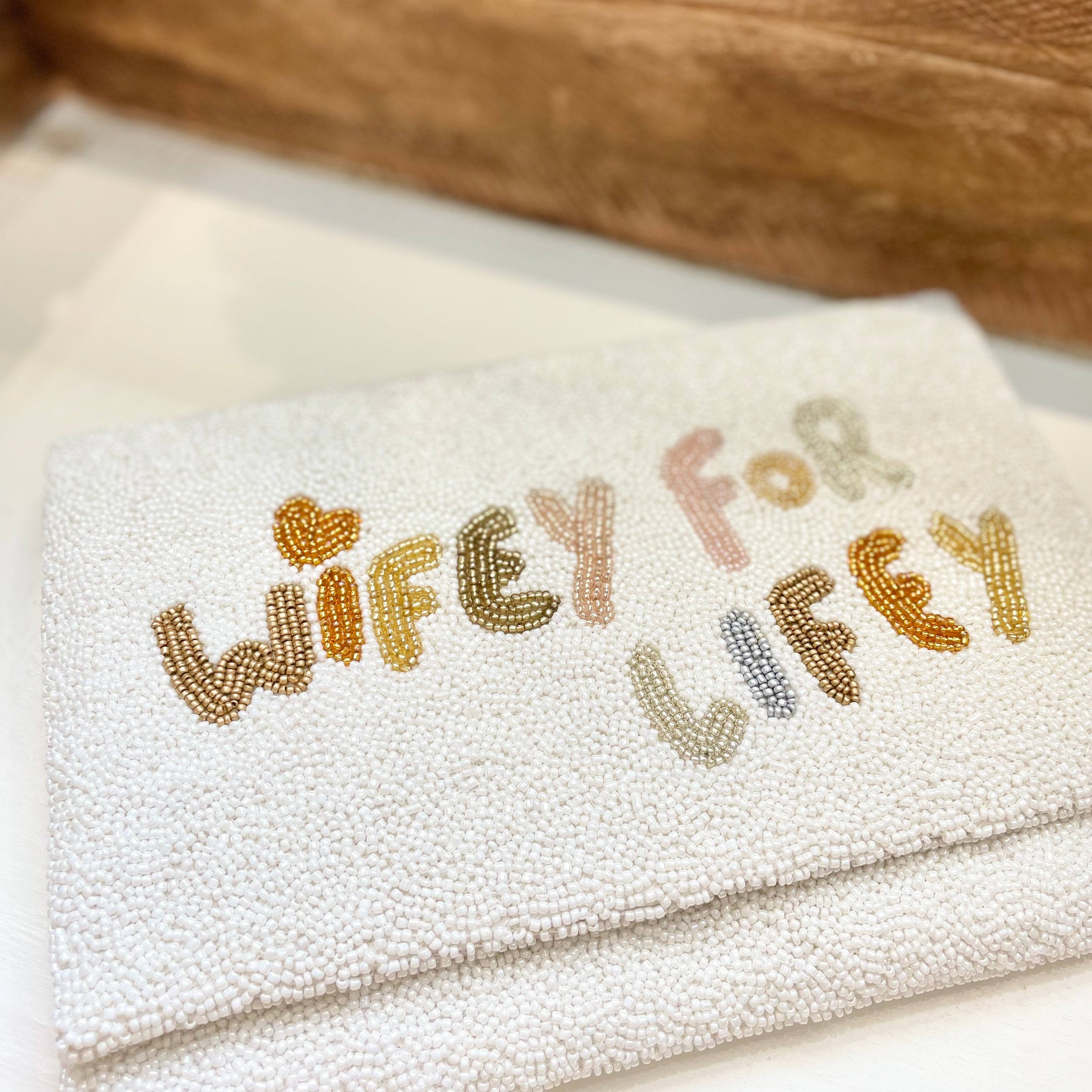 wifey for lifey beaded bridal handbag on wooden shelf