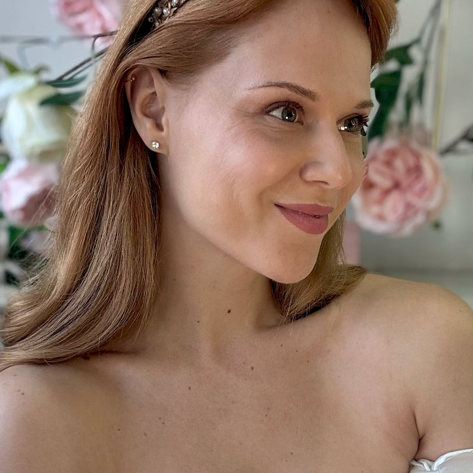Woman wearing bridal tiara with floral decorations in the background