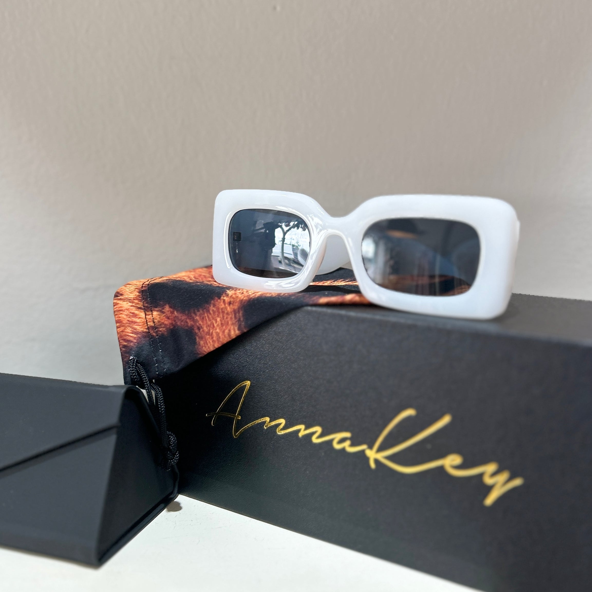 Step into the sunshine in style with the Ellie Sunglasses, the perfect accessory for the modern summer bride. Designed to turn heads, these cool white shades offer a chic, playful twist on traditional bridal style. Whether you're walking down the aisle, dancing the night away, or sipping cocktails on a sun-soaked honeymoon, the Ellie sunglasses are your go-to accessory for effortless glamour and unforgettable moments.