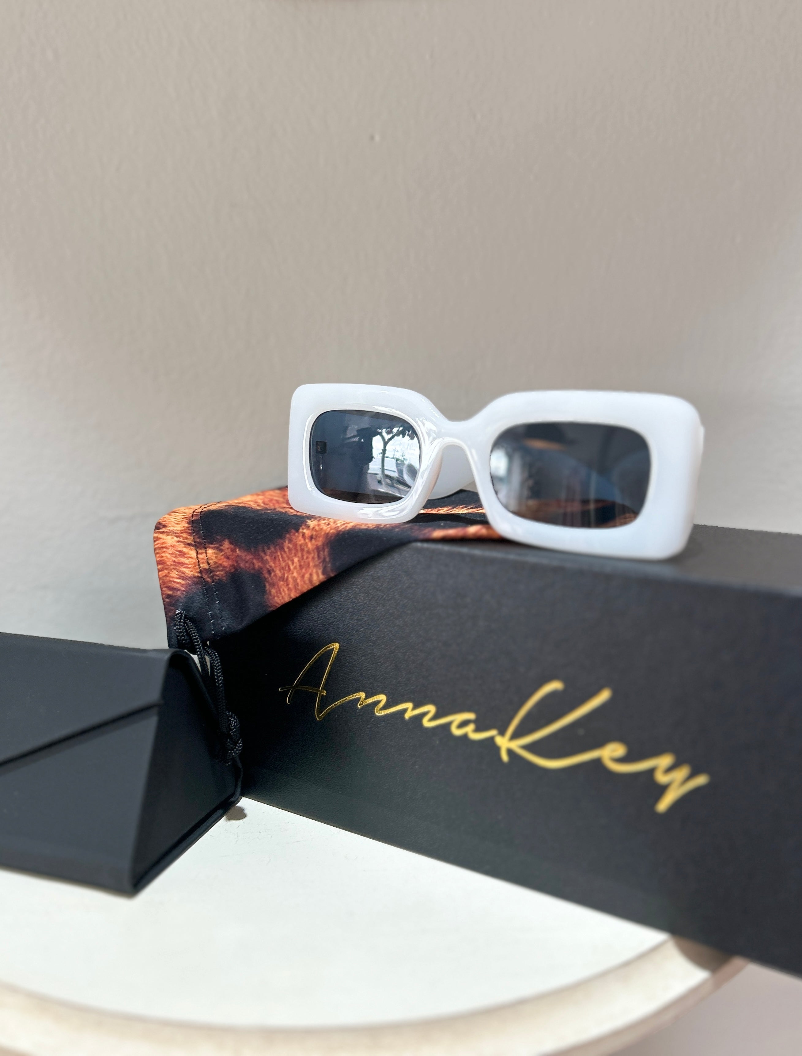 Step into the sunshine in style with the Ellie Sunglasses, the perfect accessory for the modern summer bride. Designed to turn heads, these cool white shades offer a chic, playful twist on traditional bridal style. Whether you're walking down the aisle, dancing the night away, or sipping cocktails on a sun-soaked honeymoon, the Ellie sunglasses are your go-to accessory for effortless glamour and unforgettable moments.