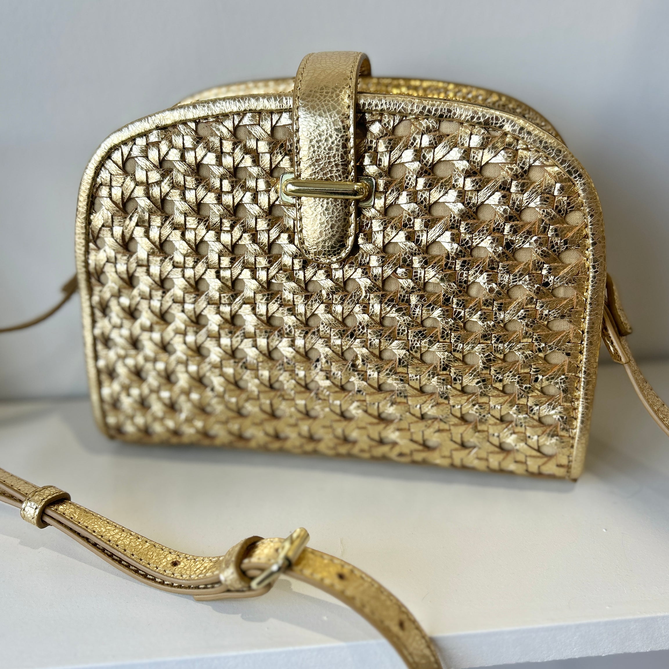 Compact gold leather crossbody clutch bag