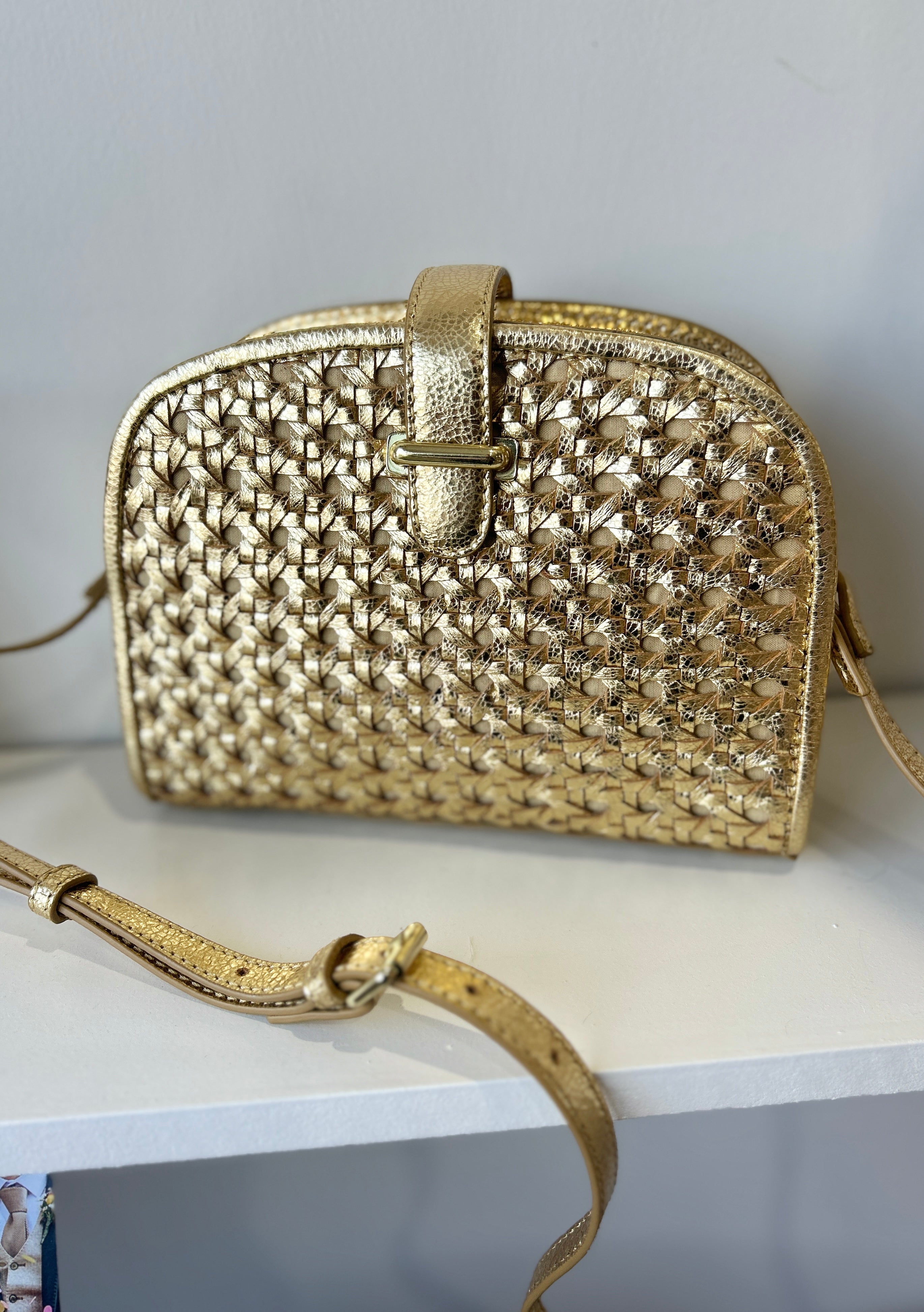 Compact gold leather crossbody clutch bag