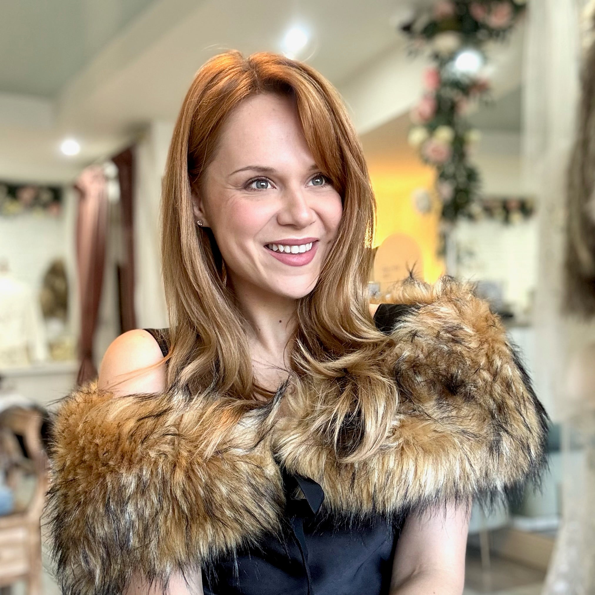 Woman wearing a faux fur stole in a store setting