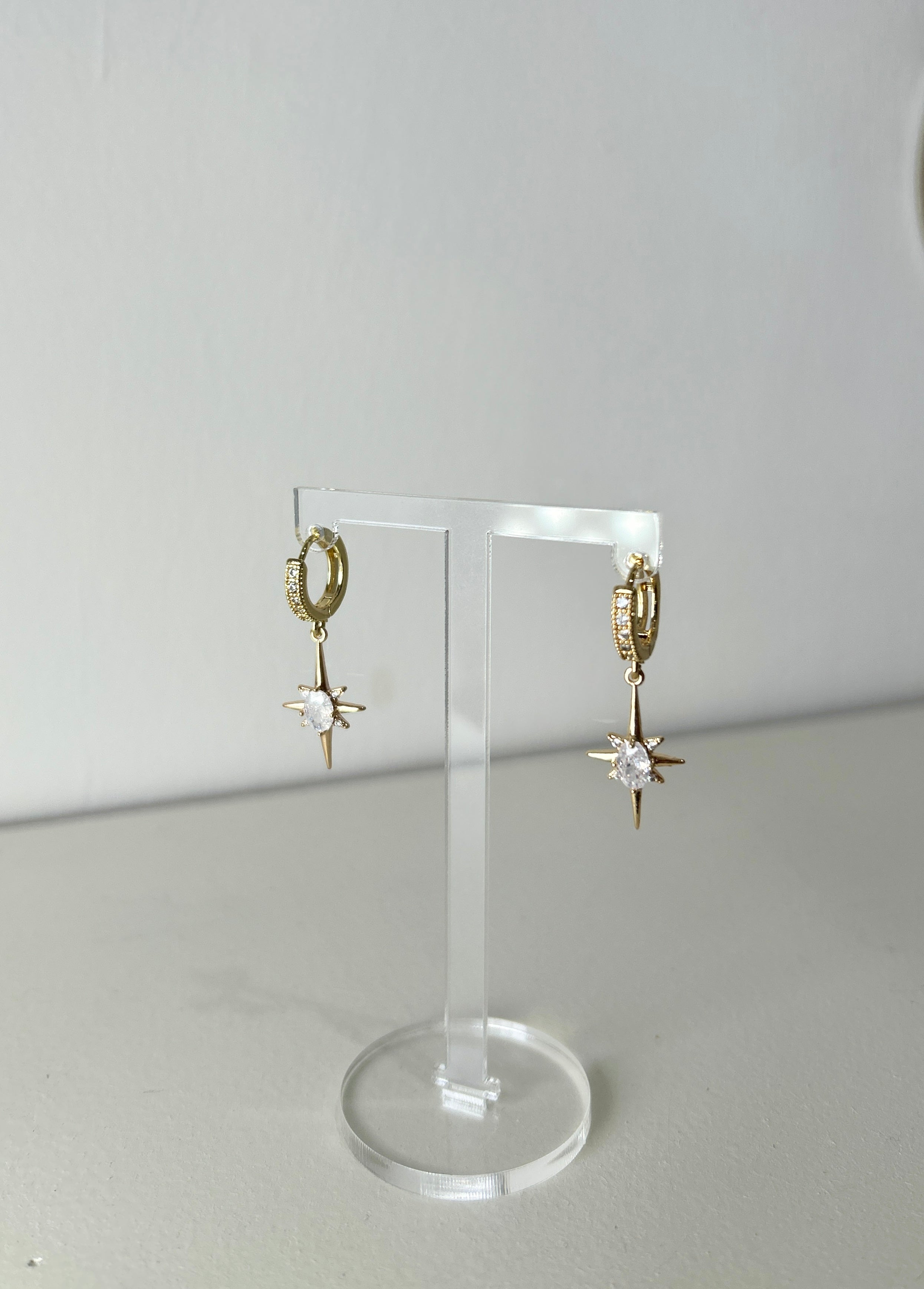 Elevate your elegance with these stunning Gold Crystal Starlet Huggie Earrings featuring a dazzling Star Drop. Designed to add a touch of glamour to any bridal or special occasion ensemble, these earrings are a must-have for your jewellery collection.