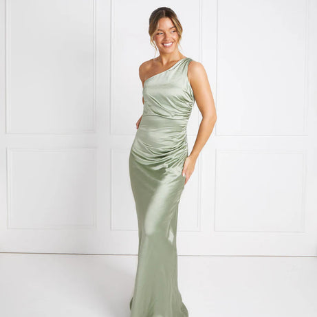 woman wearing pastel sage green one shoulder bridesmaid dress