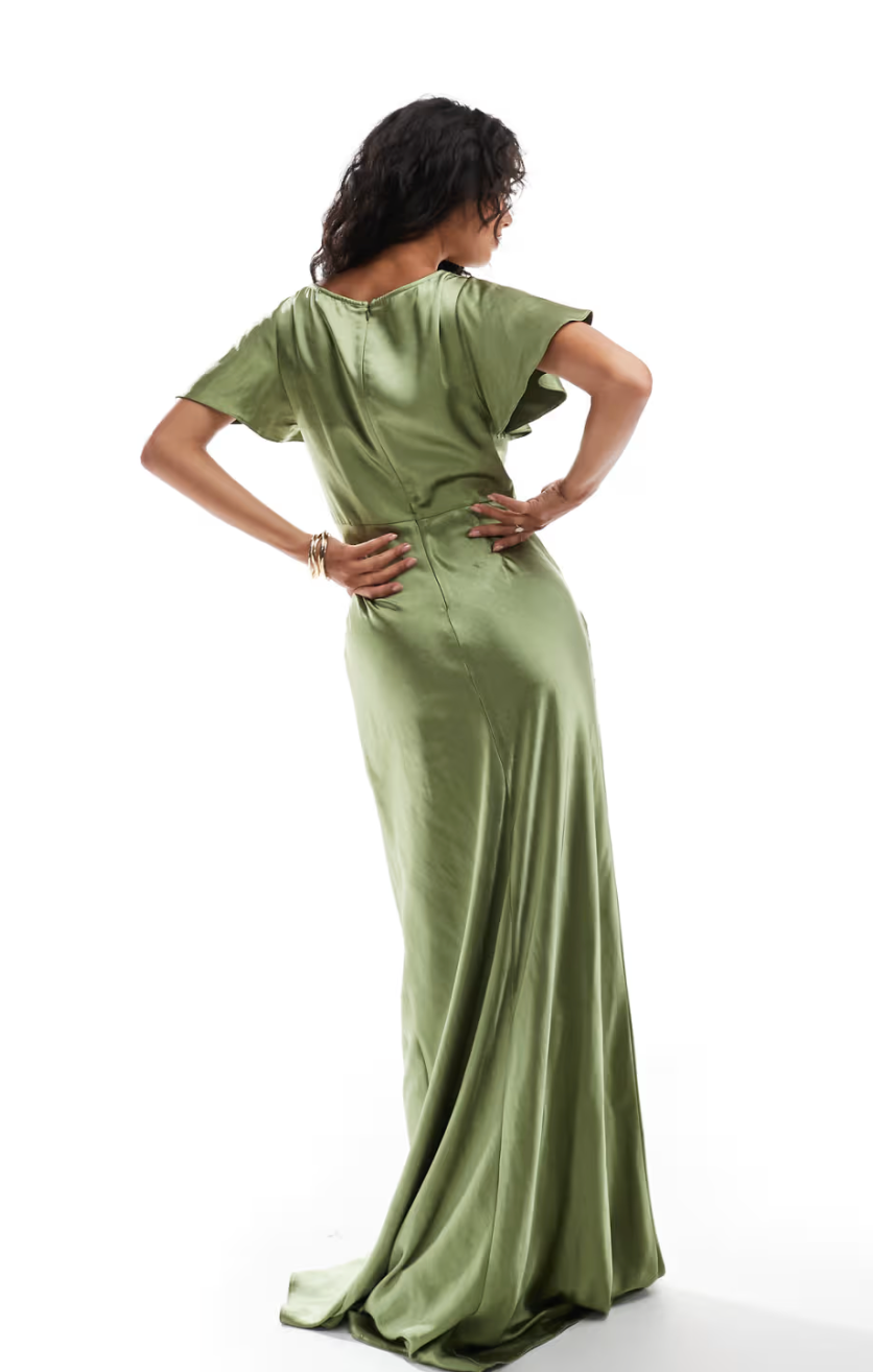 Woman wearing a moss green satin bridesmaid dress on a white background