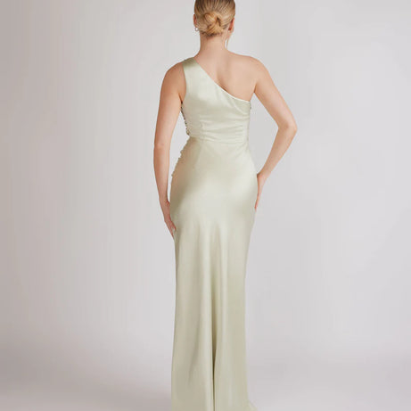 woman wearing pastel light green one shoulder bridesmaid dress