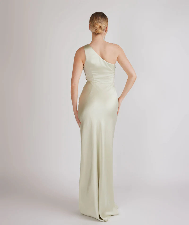 woman wearing pastel light green one shoulder bridesmaid dress
