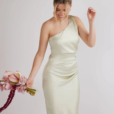 woman wearing pastel light green one shoulder bridesmaid dress