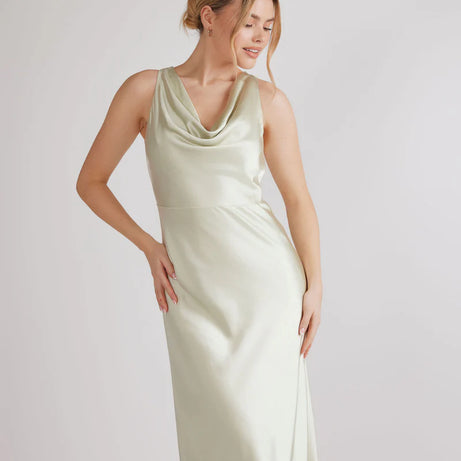 Woman wearing pastel green satin bridesmaid dress with cowl neck