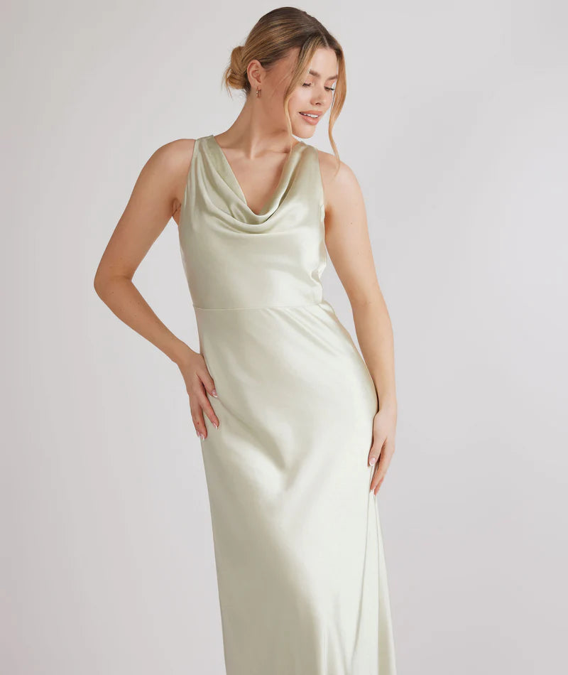 Woman wearing pastel green satin bridesmaid dress with cowl neck