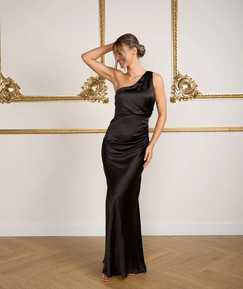 Woman wearing Six Stories Alex One shoulder bridesmaid dress in black