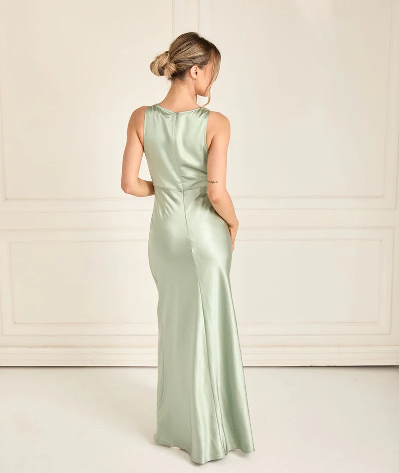 woman wearing satin bridesmaid dress in sage green with cowl neck
