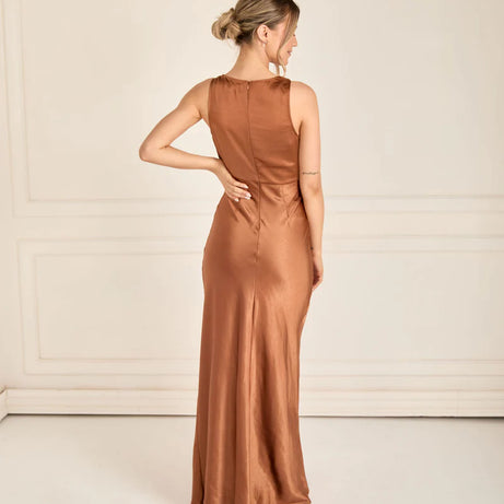 woman wearing satin bridesmaid dress in rust bronze with cowl neck