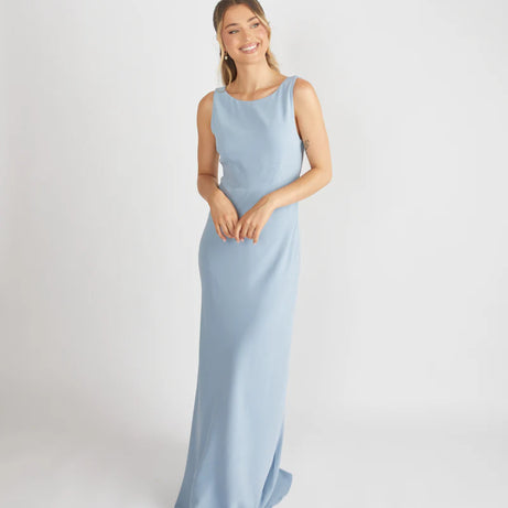 lady wearing blue cowl back bridesmaid dress by six stories
