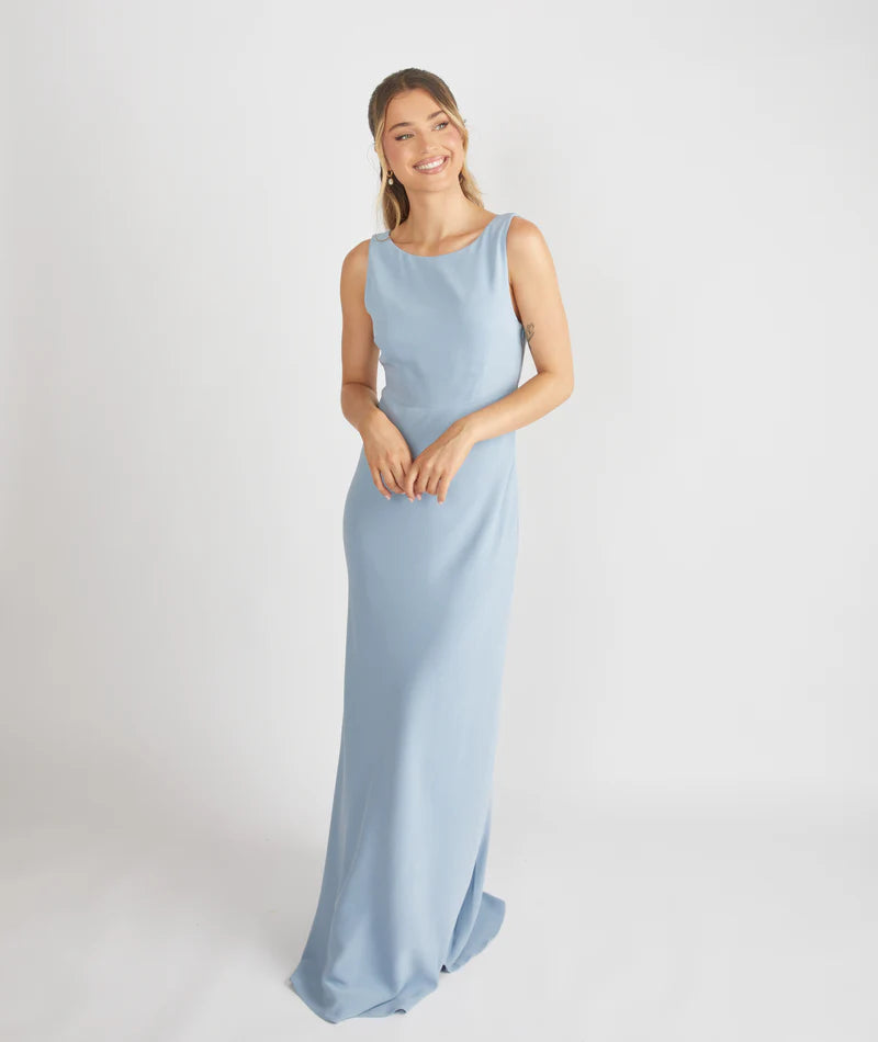 lady wearing blue cowl back bridesmaid dress by six stories