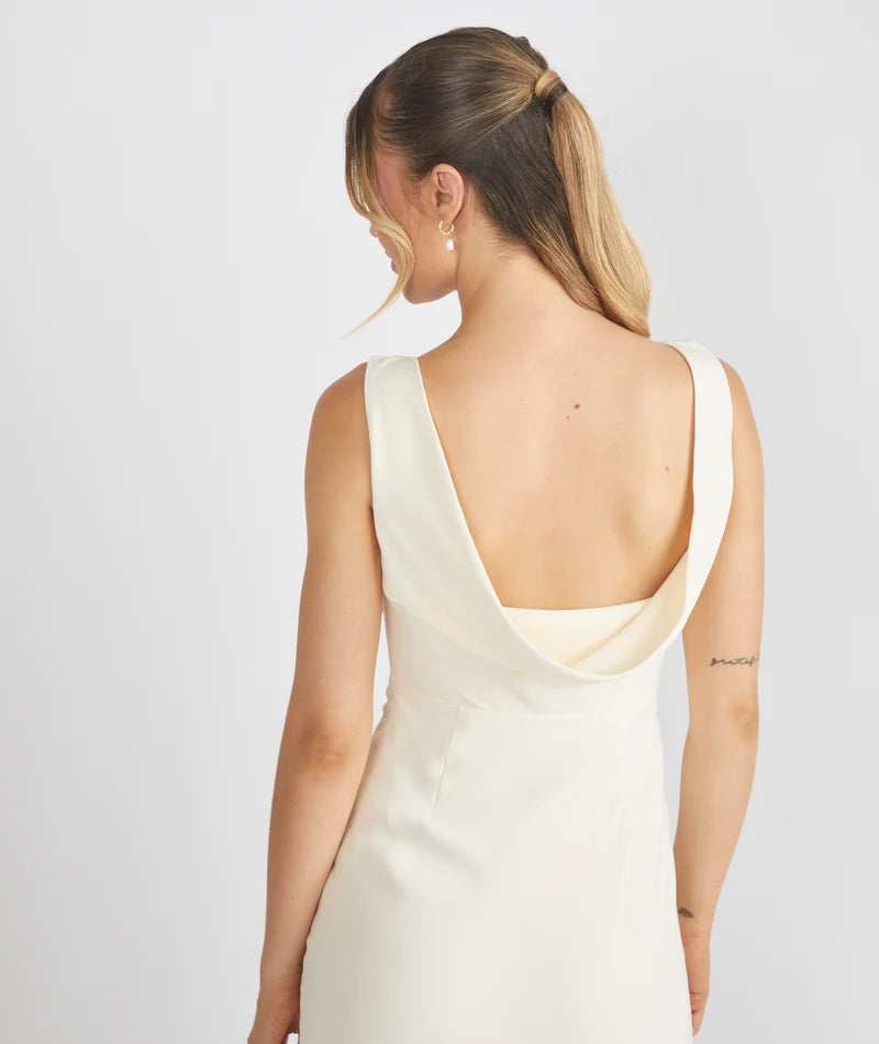 Woman wearing Six Stories crepe cowl back bridesmaid dress in colour Almond