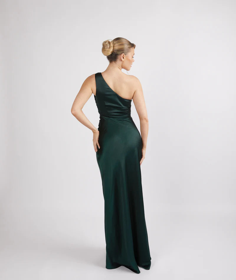 woman wearing Six Stories one shoulder satin bridesmaid dress in emerald green