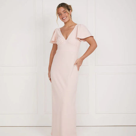 Woman wearing a pink dress against a white background