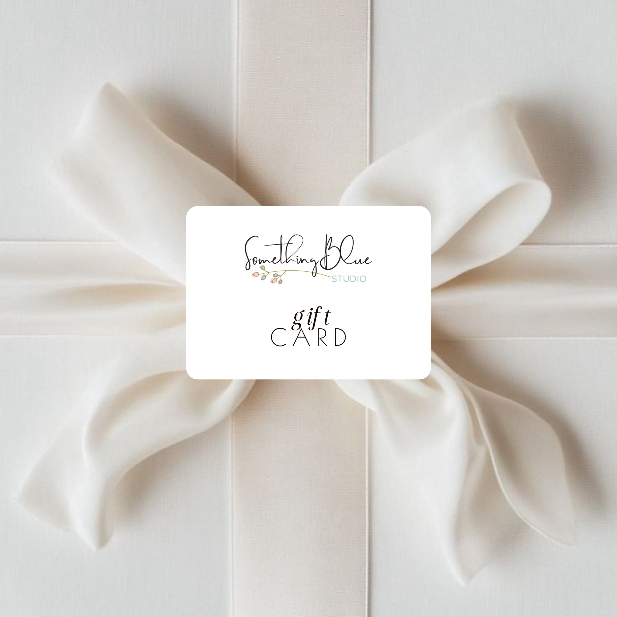 Gift card from 'Something Blue Studio' on a white bow