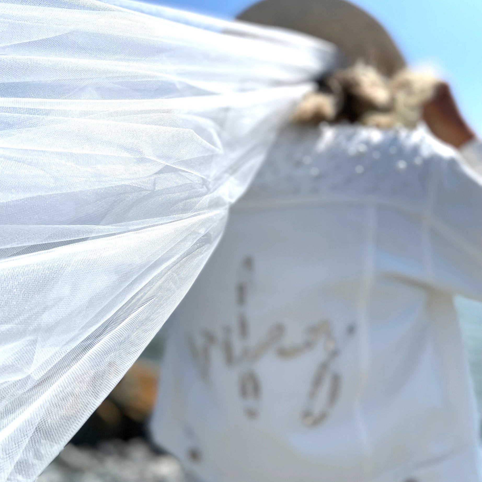 Lady wearing white wifey bridal jacket with pearl embellishments