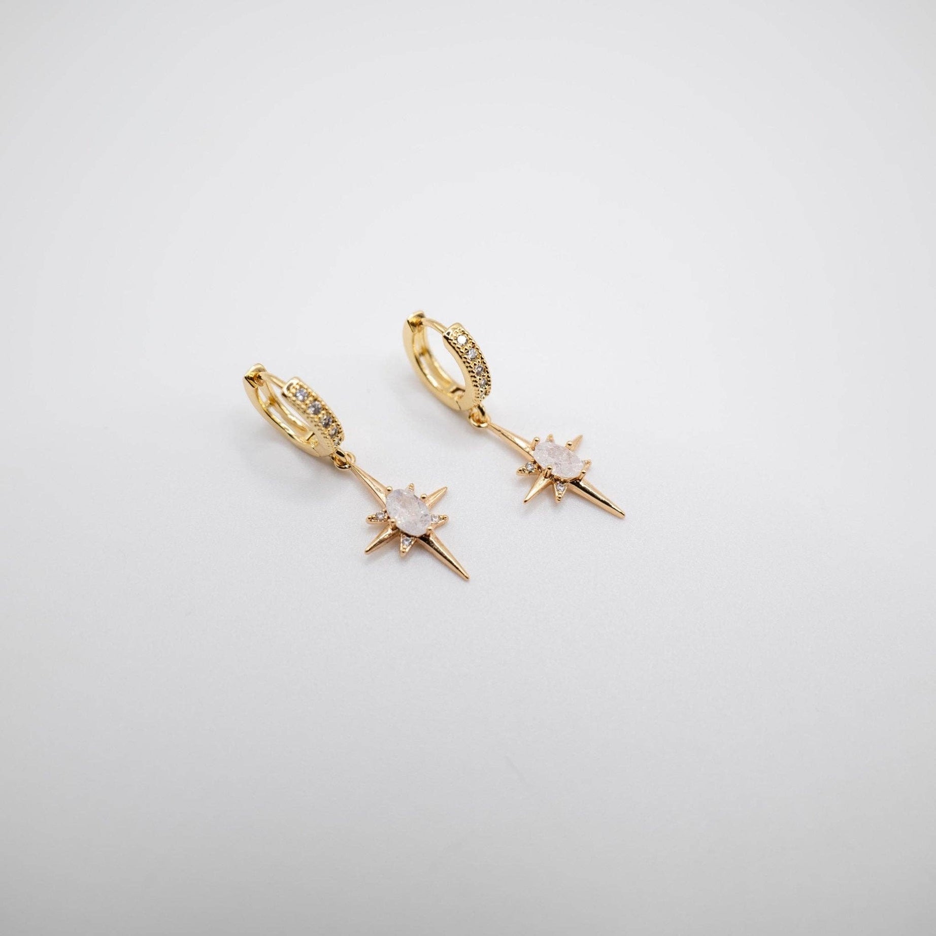 Elevate your elegance with these stunning Gold Crystal Starlet Huggie Earrings featuring a dazzling Star Drop. Designed to add a touch of glamour to any bridal or special occasion ensemble, these earrings are a must-have for your jewellery collection.
