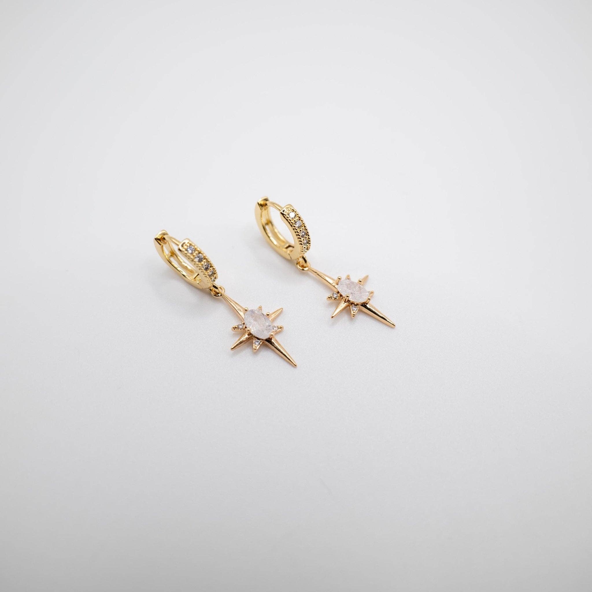 Elevate your elegance with these stunning Gold Crystal Starlet Huggie Earrings featuring a dazzling Star Drop. Designed to add a touch of glamour to any bridal or special occasion ensemble, these earrings are a must-have for your jewellery collection.