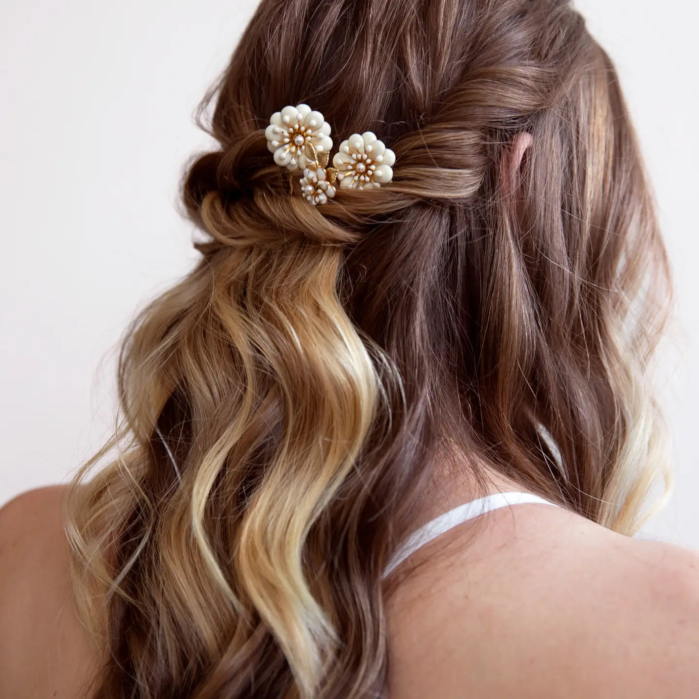 Add a touch of floral elegance to your look with the Daisy trio Hairpin Set — the perfect finishing touch for brides, bridesmaids, or anyone attending a special occasion. Handcrafted with delicate gold-toned wiring and shimmering crystal accents, these pins bring effortless elegance and luminous detail to any hairstyle.