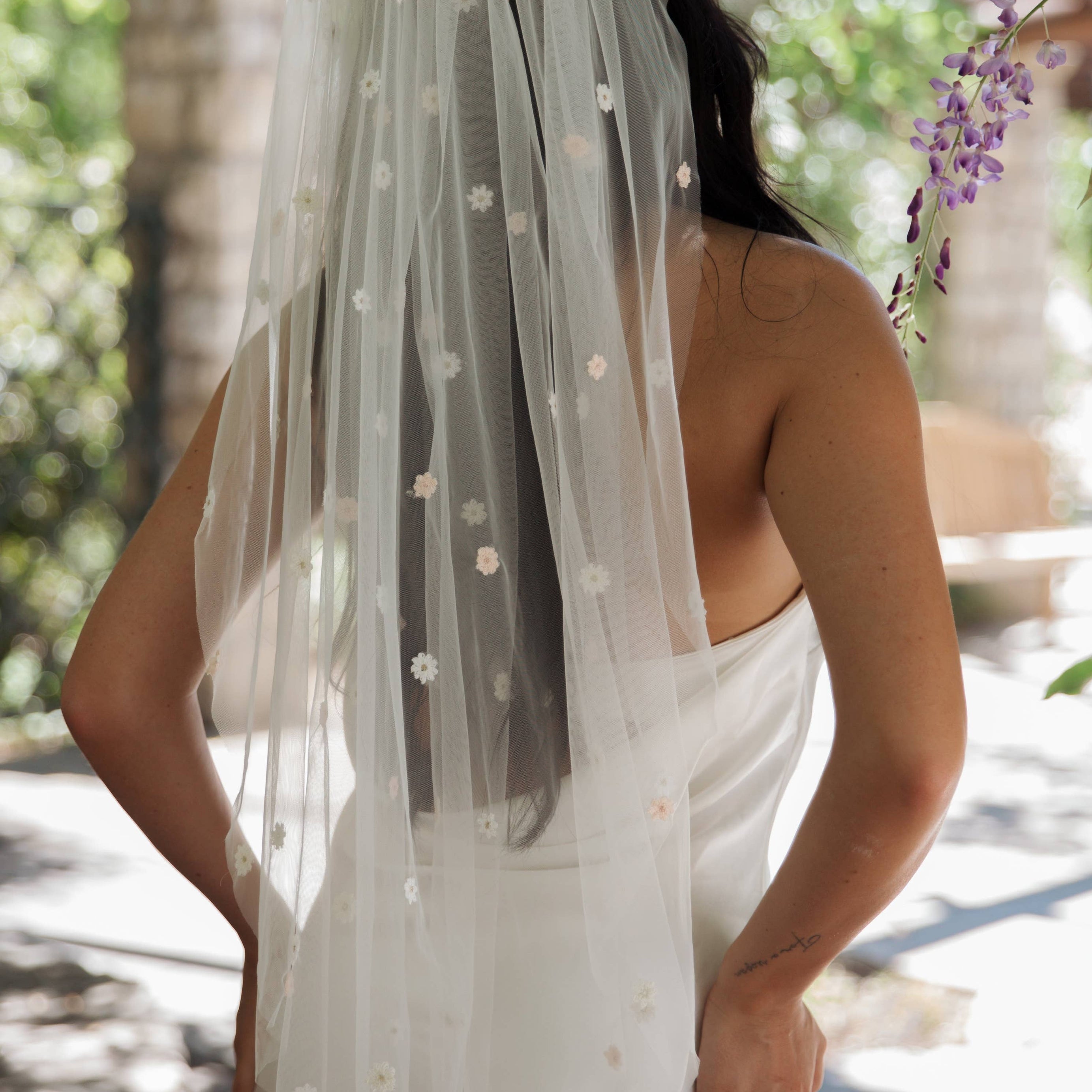 Fun and whimsical wedding veil with flowers in soft pastel shades