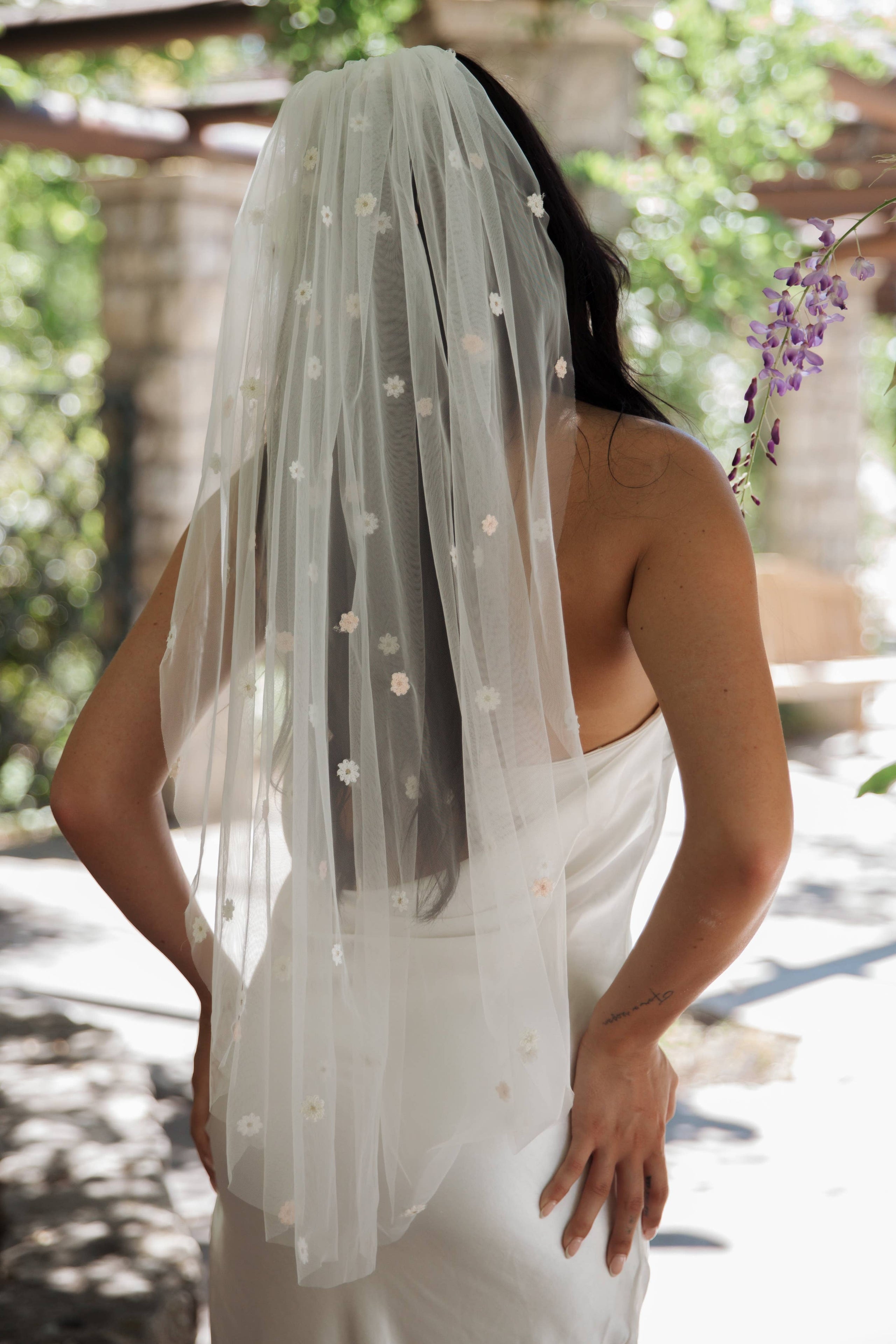 Fun and whimsical wedding veil with flowers in soft pastel shades