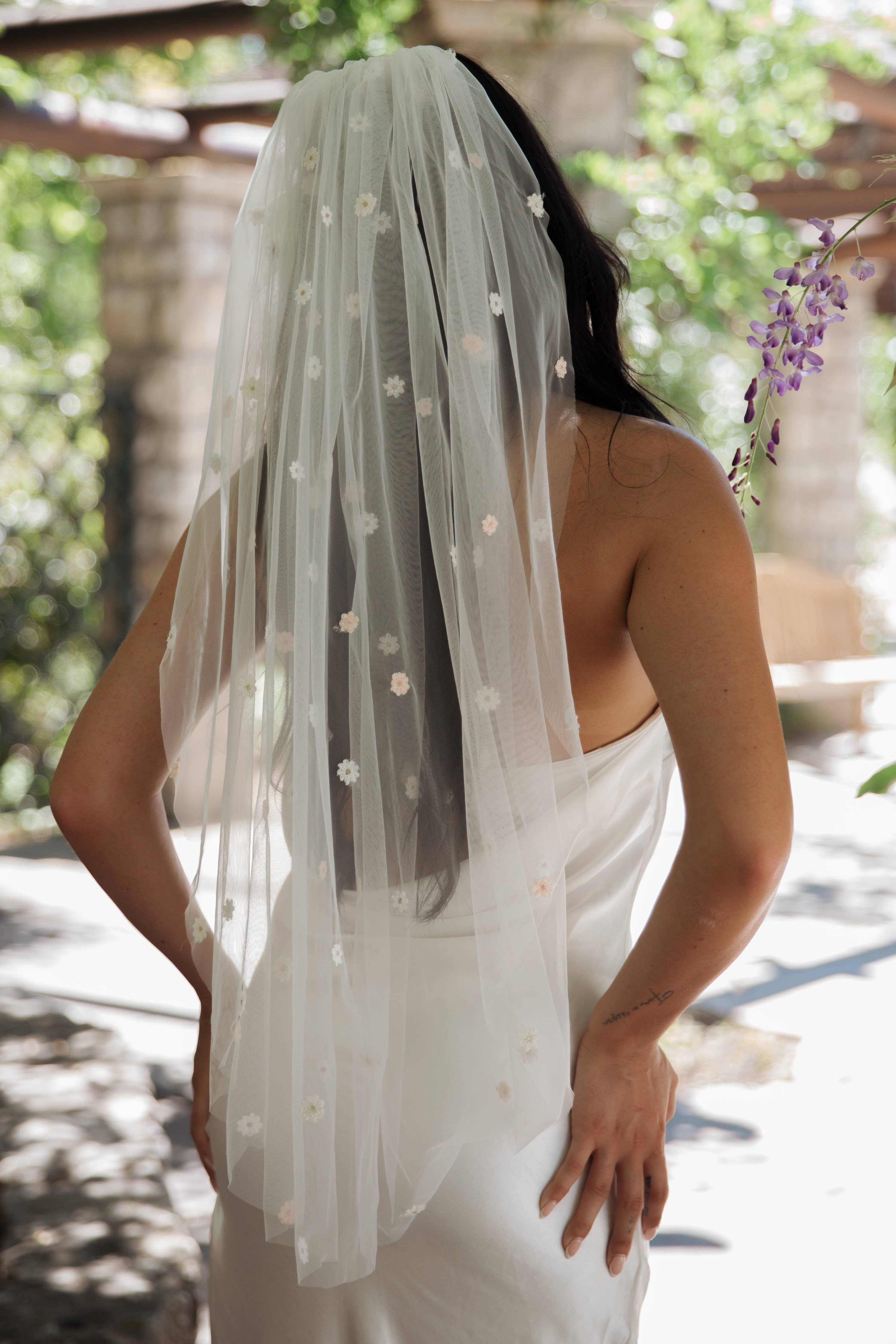 Fun and whimsical wedding veil with flowers in soft pastel shades