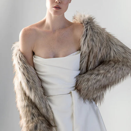 Woman wearing beige faux fur jacket