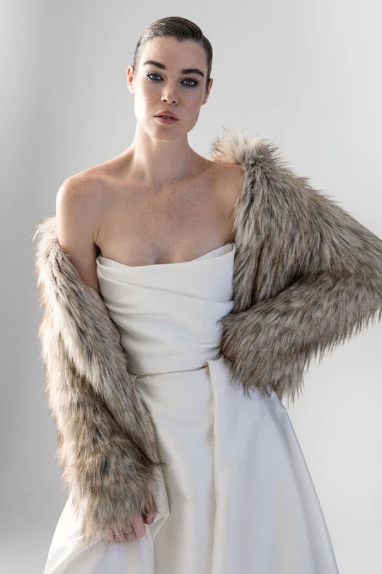 Woman wearing beige faux fur jacket