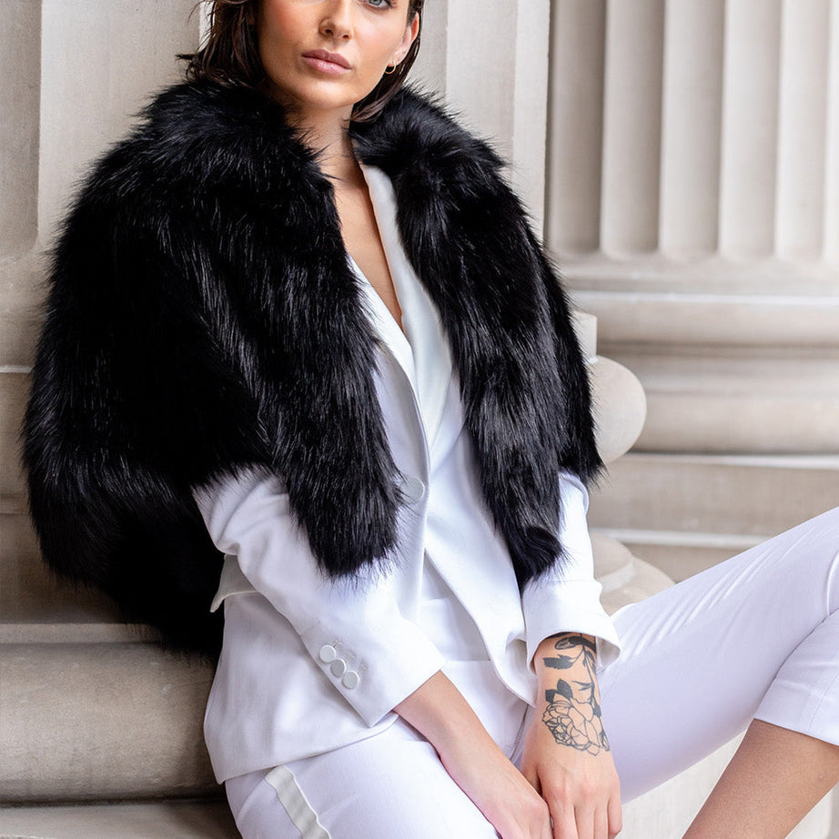 Woman wearing black faux fur cape