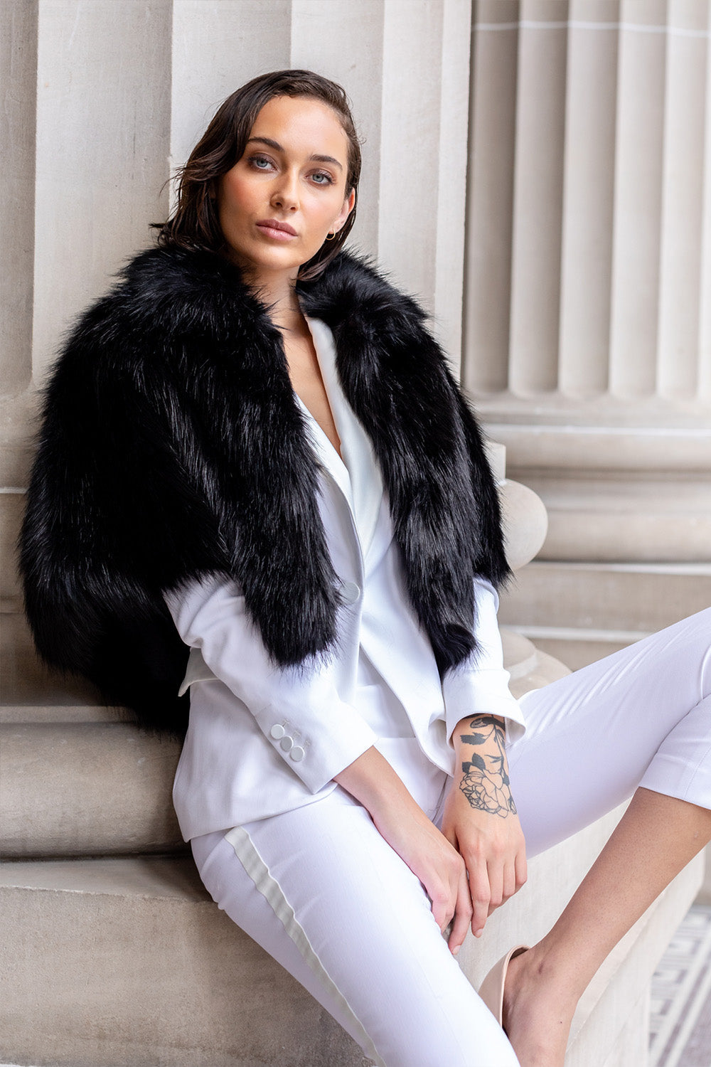 Woman wearing black faux fur cape